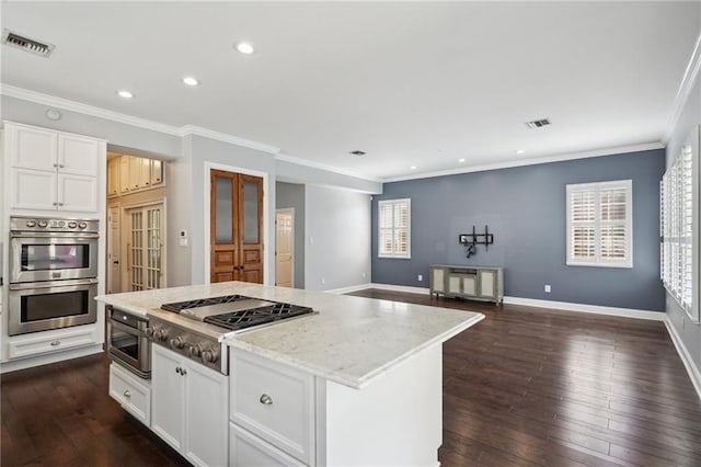 5830 Marshal Foch St, New Orleans, LA 70124 - kitchen featuring stainless steel appliances, recessed lighting, crown molding, dark wood-style floors, and white cabinets