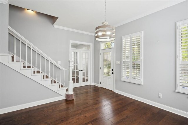 5830 Marshal Foch St, New Orleans, LA 70124 - entryway with hardwood / wood-style floors, crown molding, french doors, a chandelier, and stairs