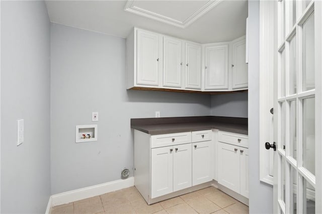 5830 Marshal Foch St, New Orleans, LA 70124 - washroom featuring hookup for a washing machine, cabinet space, light tile patterned flooring, and baseboards