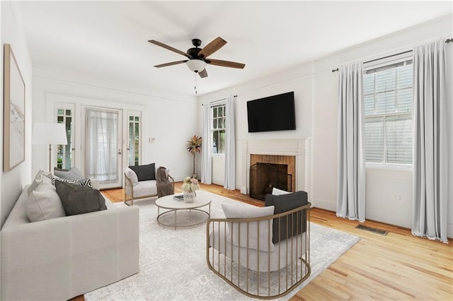 5524 S Galvez St, New Orleans, LA 70125 - living area featuring a brick fireplace, wood finished floors, and ceiling fan