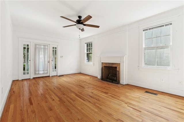 5524 S Galvez St, New Orleans, LA 70125 - unfurnished living room featuring wood finished floors, a fireplace, a ceiling fan, and baseboards
