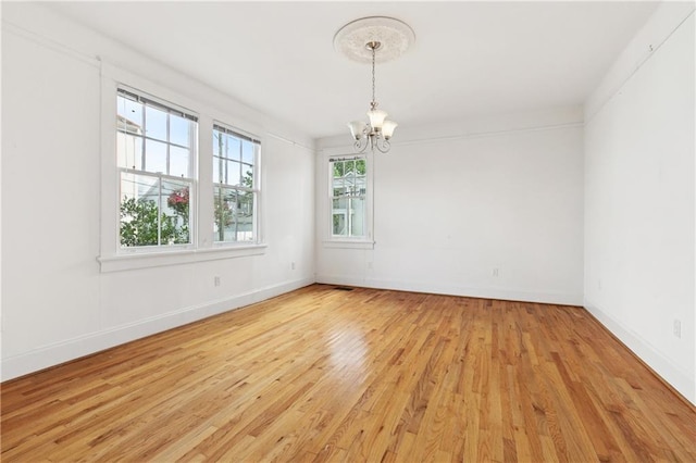 5524 S Galvez St, New Orleans, LA 70125 - unfurnished room featuring a chandelier, light wood finished floors, and baseboards