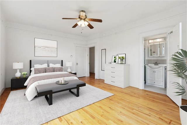 5524 S Galvez St, New Orleans, LA 70125 - bedroom with light wood-style floors, a sink, ensuite bath, and a ceiling fan