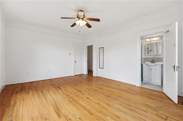 5524 S Galvez St, New Orleans, LA 70125 - unfurnished bedroom with a sink, light wood finished floors, ensuite bathroom, ceiling fan, and baseboards