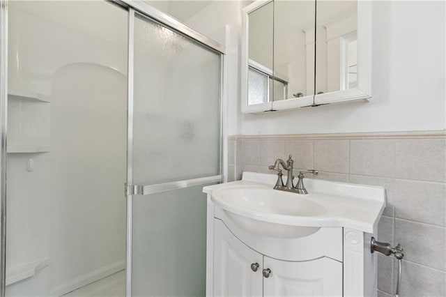 5524 S Galvez St, New Orleans, LA 70125 - bathroom with a shower stall, vanity, tile walls, and a wainscoted wall