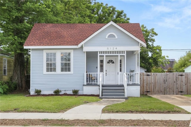 5124 Painters St, New Orleans, LA 70122 - view of front facade featuring a shingled roof and covered porch