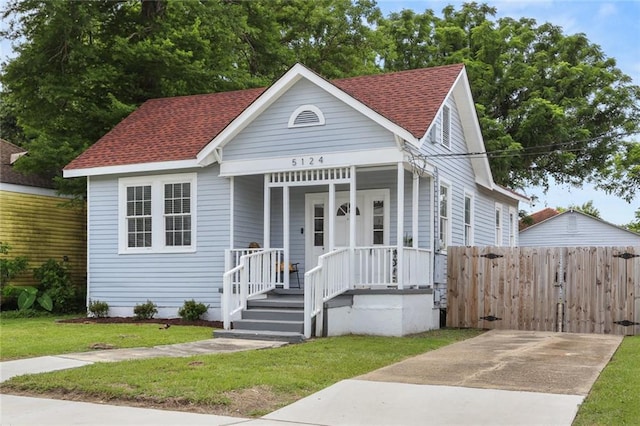 5124 Painters St, New Orleans, LA 70122 - view of front of home with roof with shingles and a porch