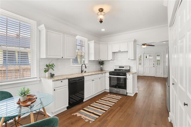 5124 Painters St, New Orleans, LA 70122 - kitchen featuring stainless steel gas range, black dishwasher, white cabinets, decorative backsplash, and crown molding