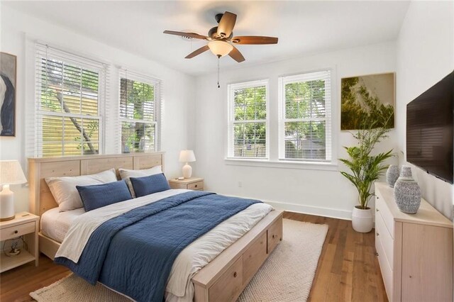 5124 Painters St, New Orleans, LA 70122 - bedroom featuring wood finished floors, baseboards, and a ceiling fan