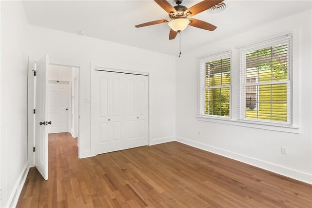 5124 Painters St, New Orleans, LA 70122 - unfurnished bedroom featuring wood finished floors, baseboards, a closet, and ceiling fan