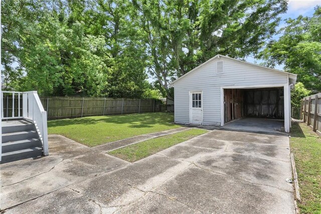 5124 Painters St, New Orleans, LA 70122 - view of yard with a garage and an outdoor structure