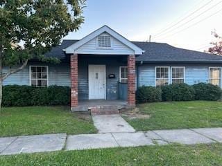 8830 Stroelitz St, New Orleans, LA 70118 - view of front facade with a front yard and a porch