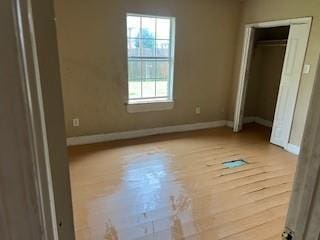 8830 Stroelitz St, New Orleans, LA 70118 - unfurnished bedroom with wood finished floors and baseboards