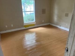 8830 Stroelitz St, New Orleans, LA 70118 - spare room with plenty of natural light, wood finished floors, and baseboards
