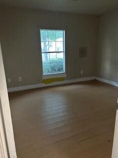 8830 Stroelitz St, New Orleans, LA 70118 - spare room featuring baseboards and wood finished floors