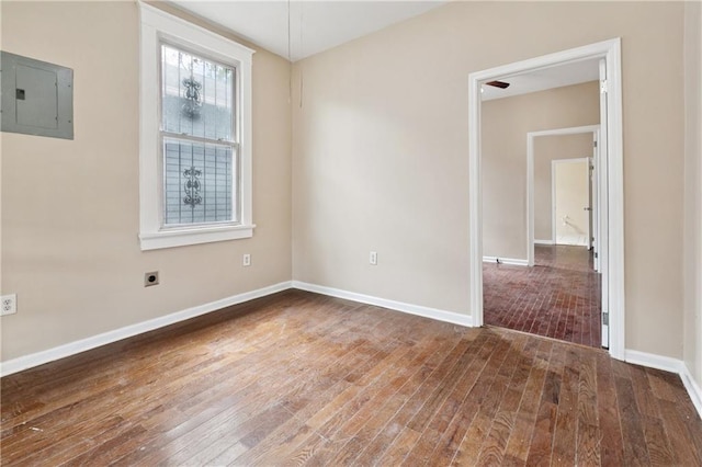 3717 S Johnson St, New Orleans, LA 70125 - unfurnished room featuring electric panel, wood finished floors, and baseboards