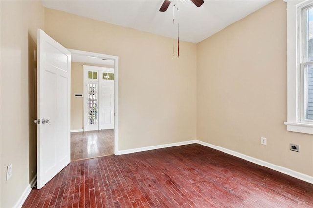 3717 S Johnson St, New Orleans, LA 70125 - unfurnished room featuring dark wood-type flooring, a ceiling fan, and baseboards