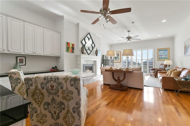 7300 Lakeshore Dr Unit 4, New Orleans, LA 70124 - living area with a high end fireplace, a ceiling fan, light wood-style flooring, recessed lighting, and ornamental molding