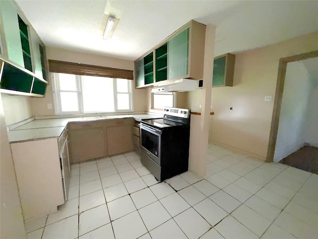 131 Celia Dr, Luling, LA 70070 - kitchen with electric stove, under cabinet range hood, open shelves, and light countertops