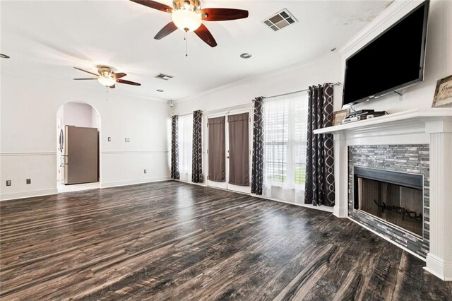 140 E Lakeview Dr, La Place, LA 70068 - unfurnished living room featuring a ceiling fan, wood finished floors, crown molding, a fireplace, and arched walkways