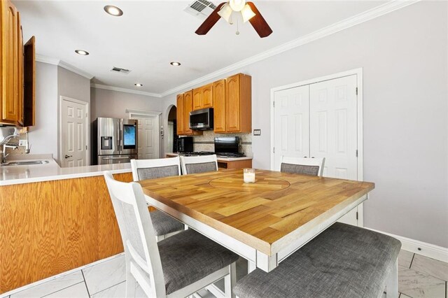 140 E Lakeview Dr, La Place, LA 70068 - dining area featuring arched walkways, light marble finish flooring, ornamental molding, ceiling fan, and recessed lighting
