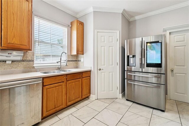 140 E Lakeview Dr, La Place, LA 70068 - kitchen featuring appliances with stainless steel finishes, light marble finish floors, backsplash, light countertops, and brown cabinets