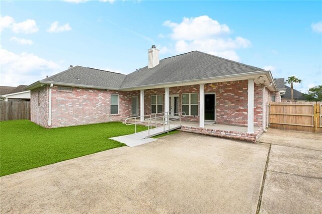 140 E Lakeview Dr, La Place, LA 70068 - back of house with a chimney, a fenced backyard, a shingled roof, and brick siding