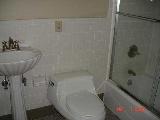 360 Vinet Ave, Jefferson, LA 70121 - bathroom featuring tile walls, toilet, and shower / bath combination with glass door
