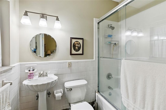 360 Vinet Ave, Jefferson, LA 70121 - full bathroom featuring bath / shower combo with glass door, tile walls, and a wainscoted wall