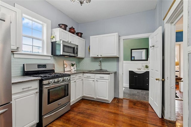 3221 N Rampart St Unit 3221, New Orleans, LA 70117 - kitchen featuring stainless steel appliances, a sink, white cabinets, and tasteful backsplash