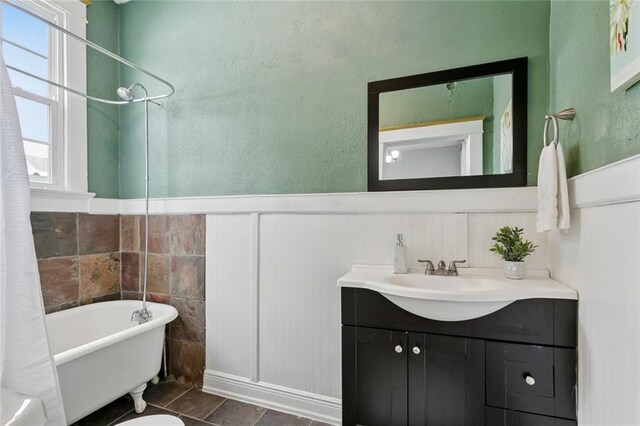 3221 N Rampart St Unit 3221, New Orleans, LA 70117 - full bathroom with vanity, a wainscoted wall, a decorative wall, and tile patterned flooring