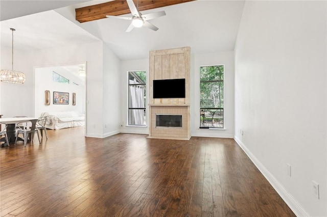 103 Catalpa Ln Unit 231, Mandeville, LA 70471 - living area featuring a large fireplace, dark wood-style flooring, a chandelier, and baseboards