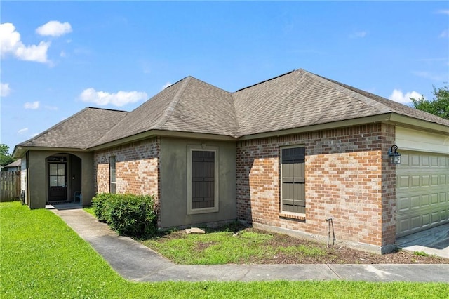 3346 Southlake Ave, Baton Rouge, LA 70818 - view of front of home with a garage, a shingled roof, brick siding, and a front yard