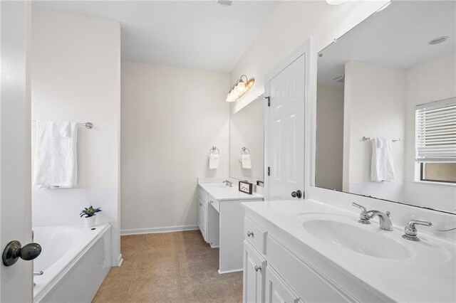 3346 Southlake Ave, Baton Rouge, LA 70818 - full bathroom with two vanities, a bath, baseboards, and tile patterned floors