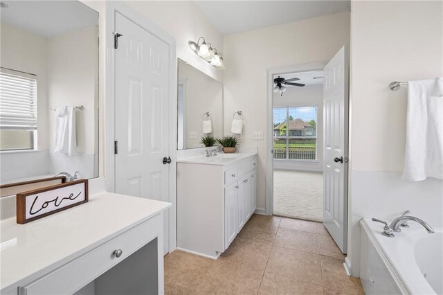 3346 Southlake Ave, Baton Rouge, LA 70818 - bathroom with vanity, a garden tub, a ceiling fan, and tile patterned floors