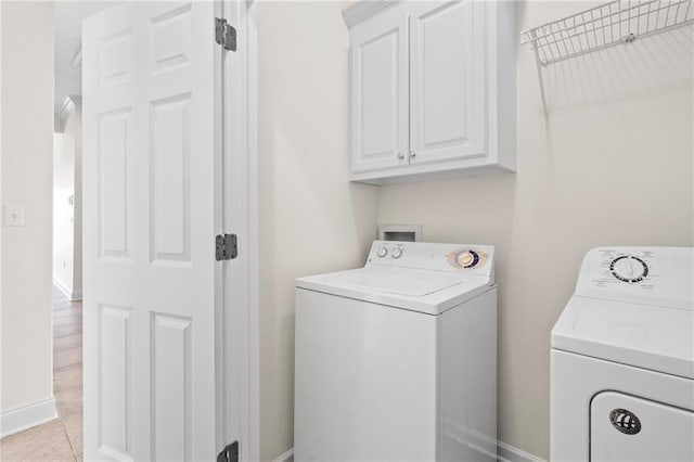 3346 Southlake Ave, Baton Rouge, LA 70818 - washroom with washer and dryer, cabinet space, baseboards, and light tile patterned floors