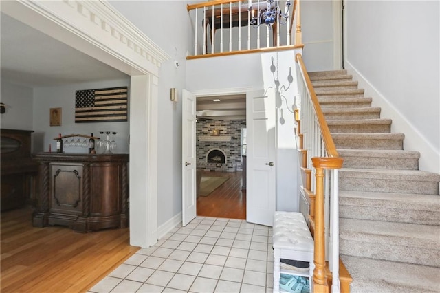 41 Yellowstone Dr, New Orleans, LA 70131 - entryway with a fireplace, stairway, light wood-style flooring, and baseboards