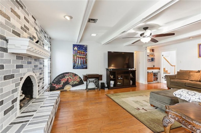 41 Yellowstone Dr, New Orleans, LA 70131 - living room with a ceiling fan, a fireplace, beamed ceiling, and wood finished floors
