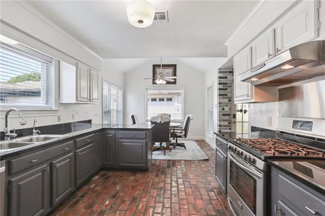 41 Yellowstone Dr, New Orleans, LA 70131 - kitchen with stainless steel range with gas cooktop, under cabinet range hood, a sink, gray cabinetry, and vaulted ceiling