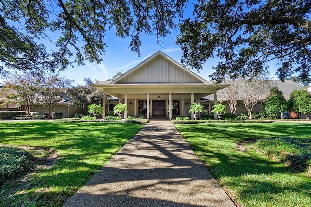 585 Beau Chene Dr, Mandeville, LA 70471 - view of front facade with a front yard, a porch, and board and batten siding