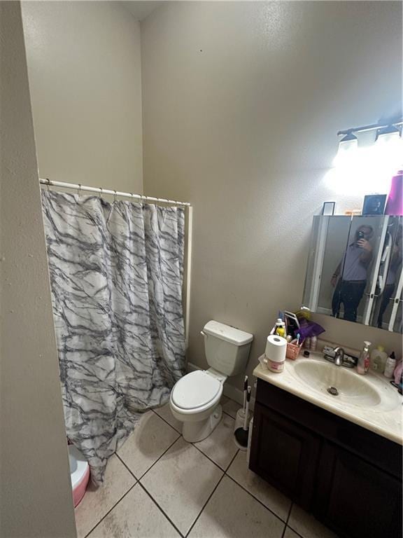 33537 Elmira Ave, New Orleans, LA 70114 - full bath with toilet, vanity, tile patterned floors, and a shower with curtain