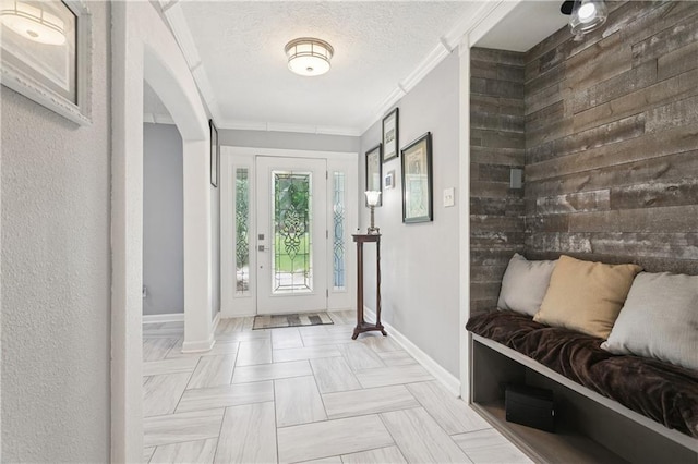 2018 Old River Rd, Slidell, LA 70461 - entrance foyer featuring baseboards, crown molding, arched walkways, and a textured ceiling
