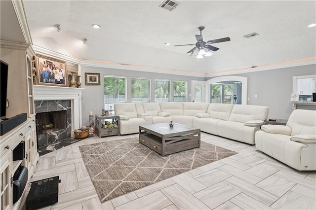 2018 Old River Rd, Slidell, LA 70461 - living area featuring a ceiling fan, healthy amount of natural light, a fireplace, a textured ceiling, and crown molding