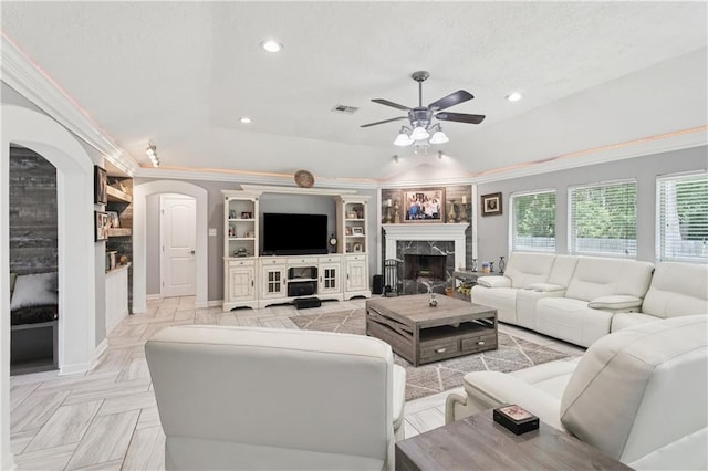 2018 Old River Rd, Slidell, LA 70461 - living area featuring a ceiling fan, a premium fireplace, ornamental molding, recessed lighting, and arched walkways