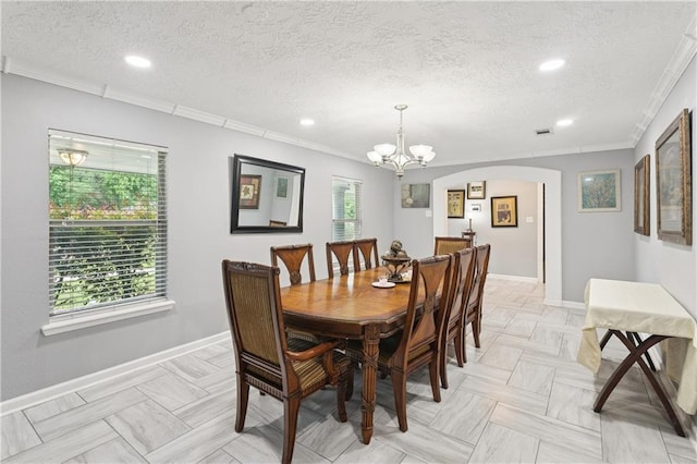 2018 Old River Rd, Slidell, LA 70461 - dining room featuring a textured ceiling, crown molding, arched walkways, recessed lighting, and baseboards