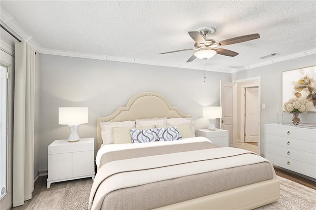 2018 Old River Rd, Slidell, LA 70461 - bedroom featuring ornamental molding, a textured ceiling, wood finished floors, and a ceiling fan