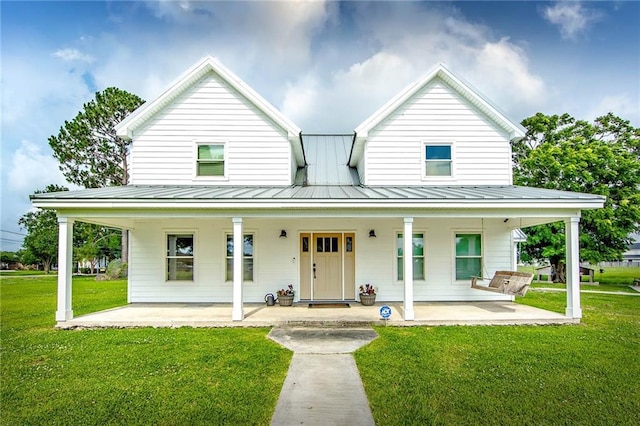 123 Willow Ct, Raceland, LA 70394 - country-style home with a standing seam roof, a front lawn, and metal roof