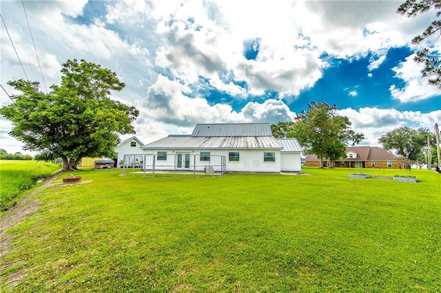 123 Willow Ct, Raceland, LA 70394 - rear view of property featuring a lawn and metal roof