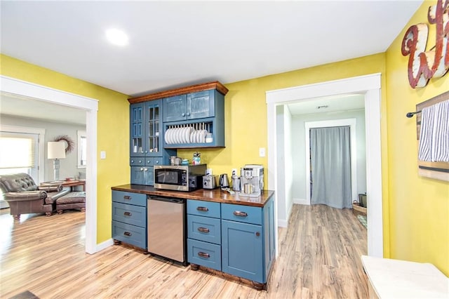 123 Willow Ct, Raceland, LA 70394 - kitchen featuring stainless steel microwave, blue cabinetry, light wood-style floors, and butcher block countertops