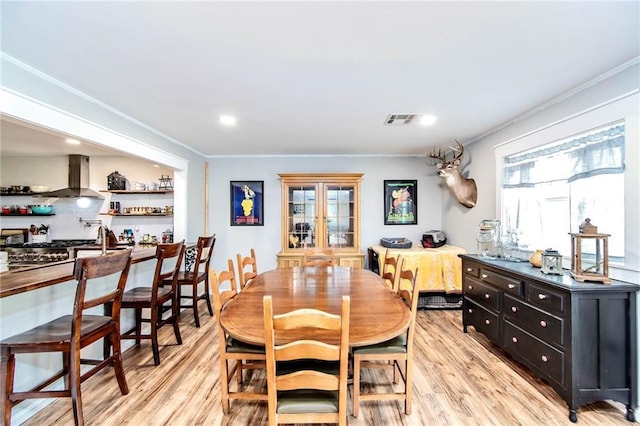 123 Willow Ct, Raceland, LA 70394 - dining room featuring light wood-style flooring, crown molding, and recessed lighting